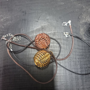 Necklace and gold or copper ball